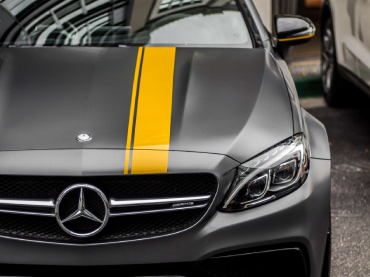 Close up image of a dark grey Mercedes